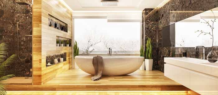 Luxurious modern bathroom with a soaking tub and large window. Features wooden floors and marble walls.
