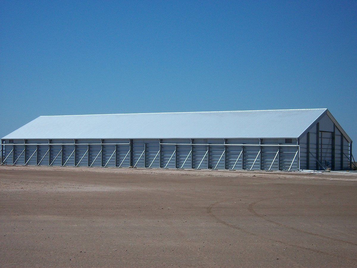 A large white building with a blue sky in the background