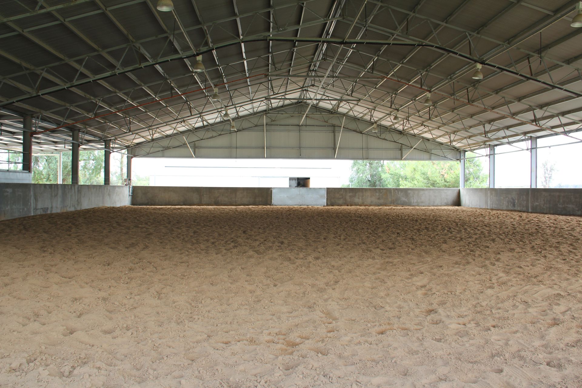 A warehouse filled with lots of hay bales stacked on top of each other.