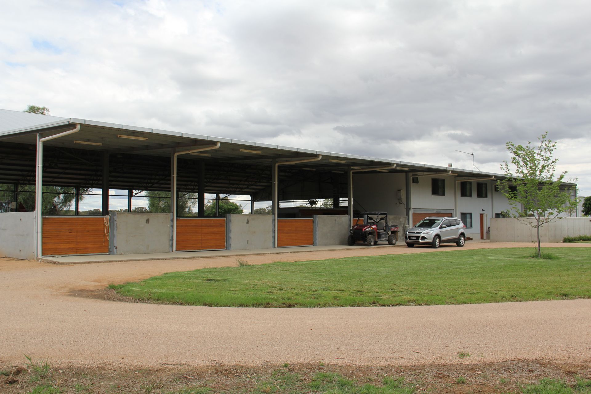 A white truck is parked in front of a large building