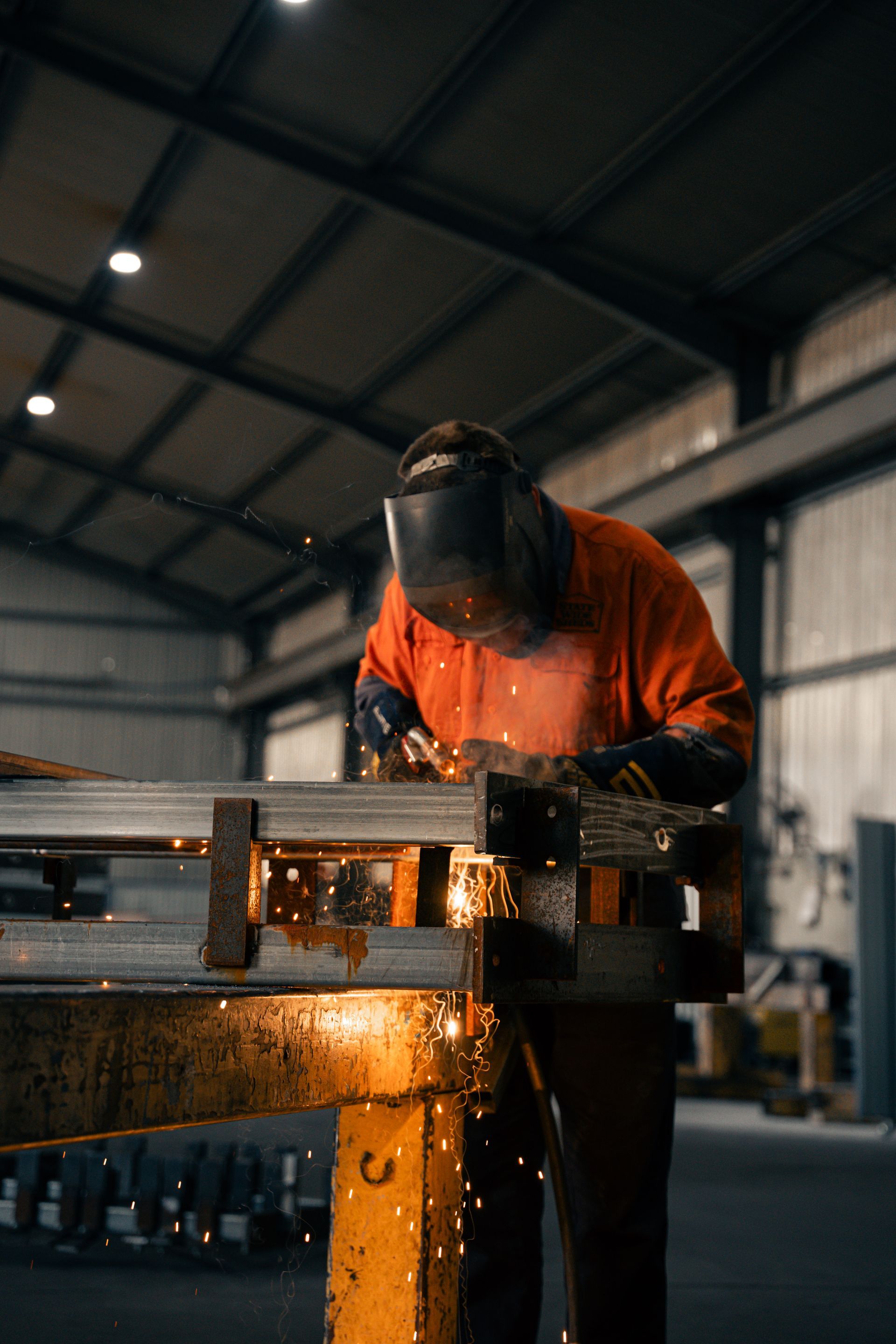 A man in a cowboy hat is standing in front of trucks