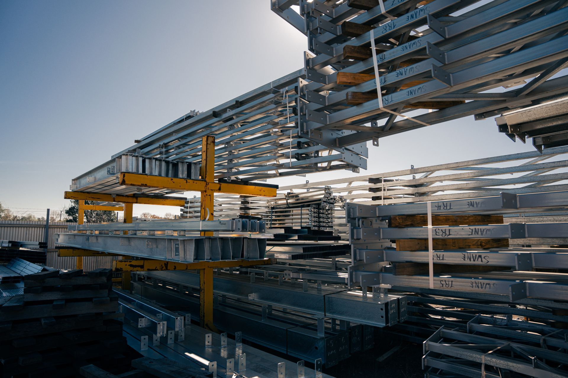 A bunch of metal pieces are stacked on top of each other in a factory.