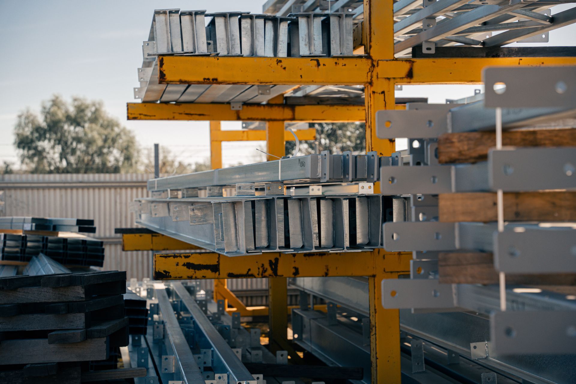 A warehouse filled with lots of metal pieces and pallets.