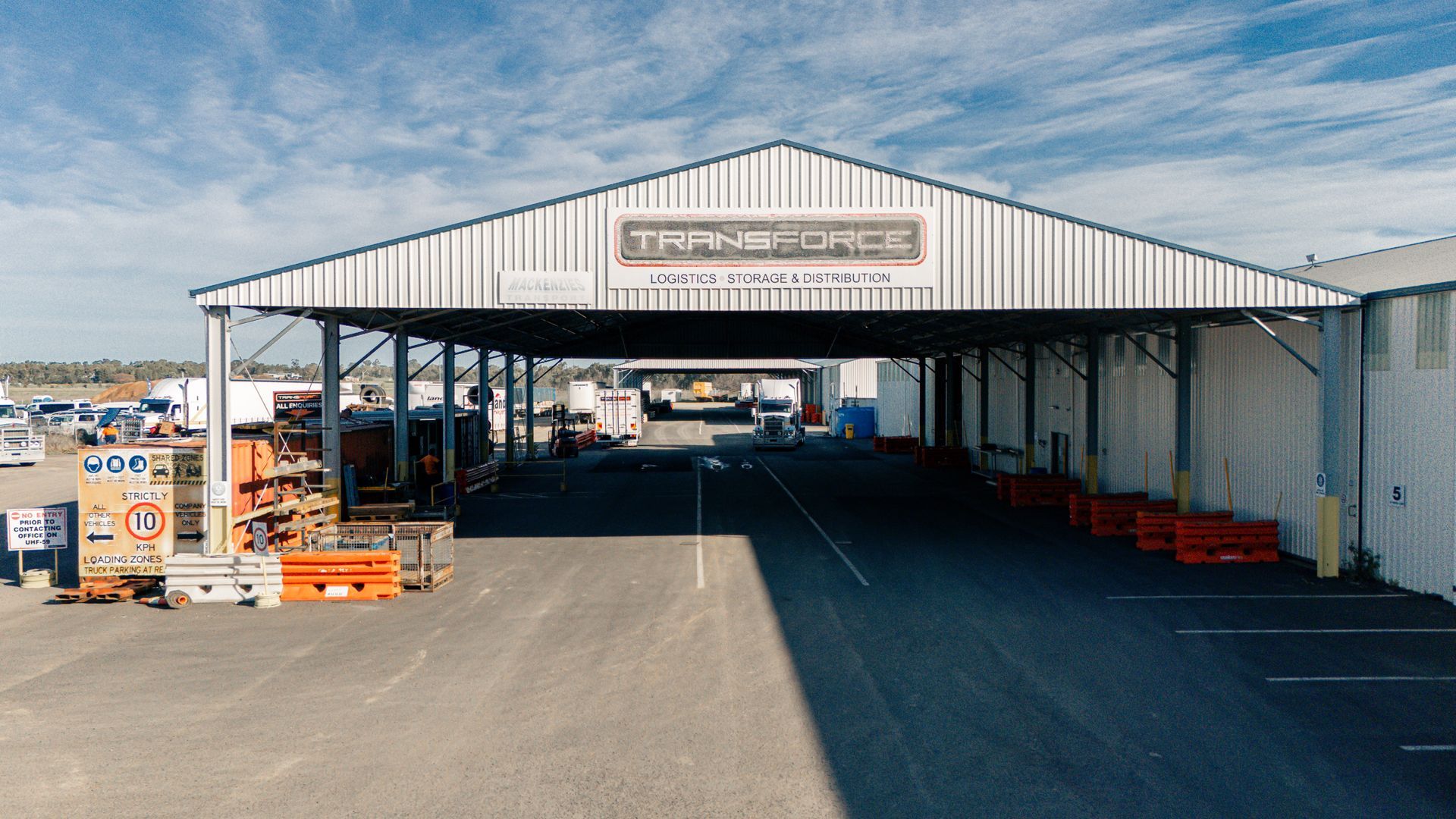 An aerial view of a large warehouse with a large roof.