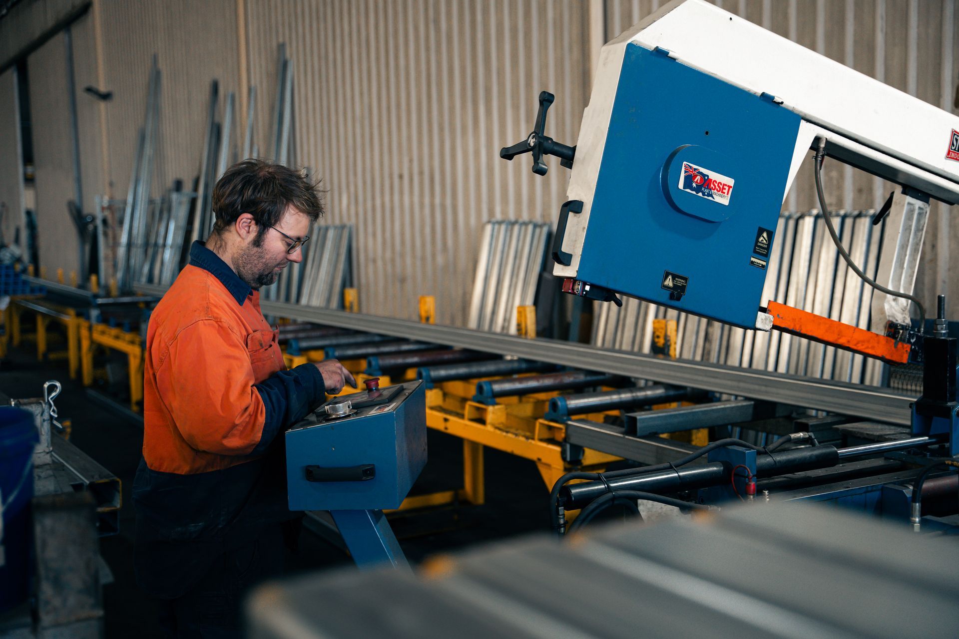 A man is working on a machine in a factory.