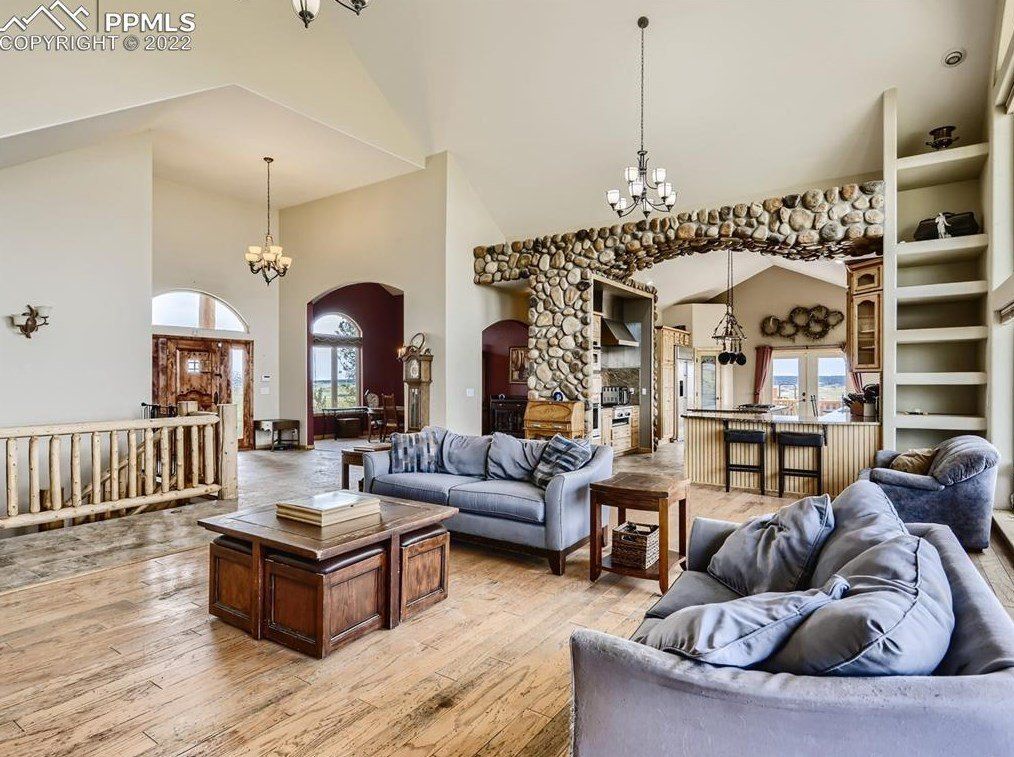A living room with a couch , chairs and a coffee table