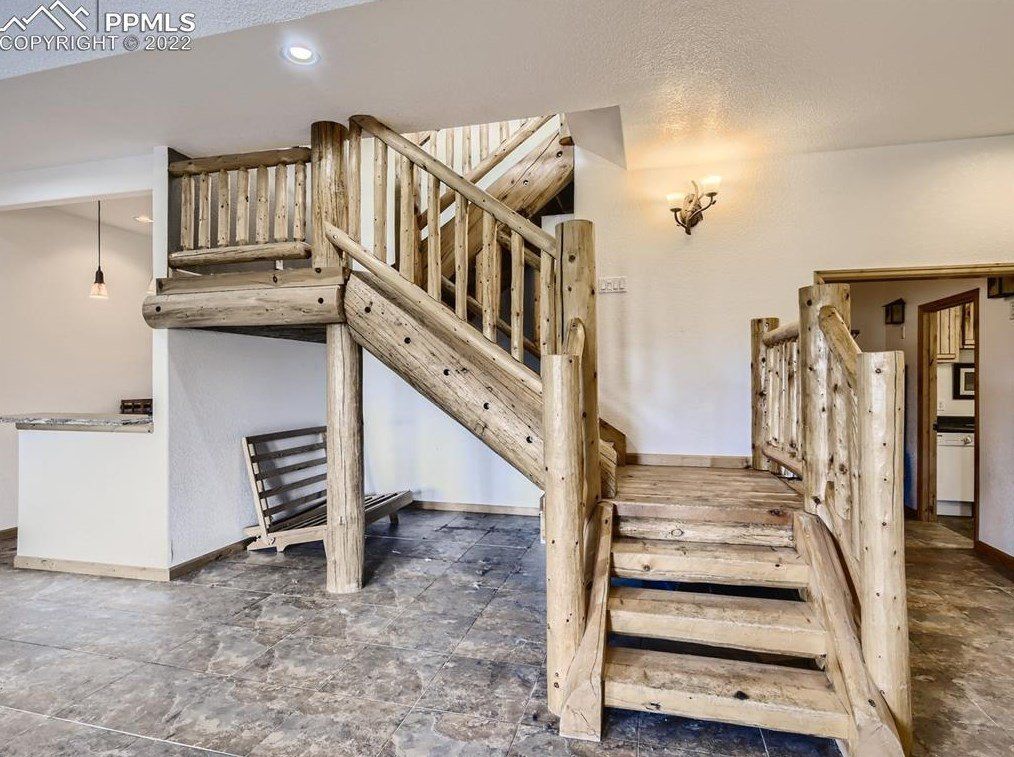 A wooden staircase leading up to a second floor in a house.