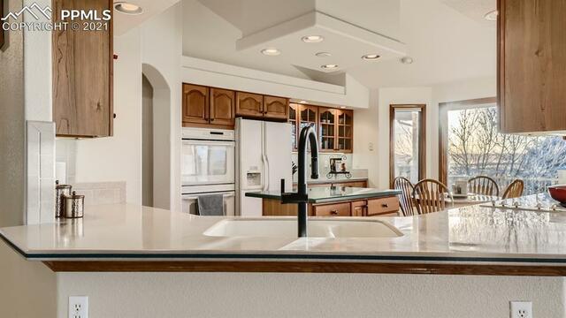 A kitchen with a sink and a refrigerator in it.