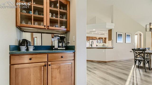 A kitchen with wooden cabinets and a coffee maker