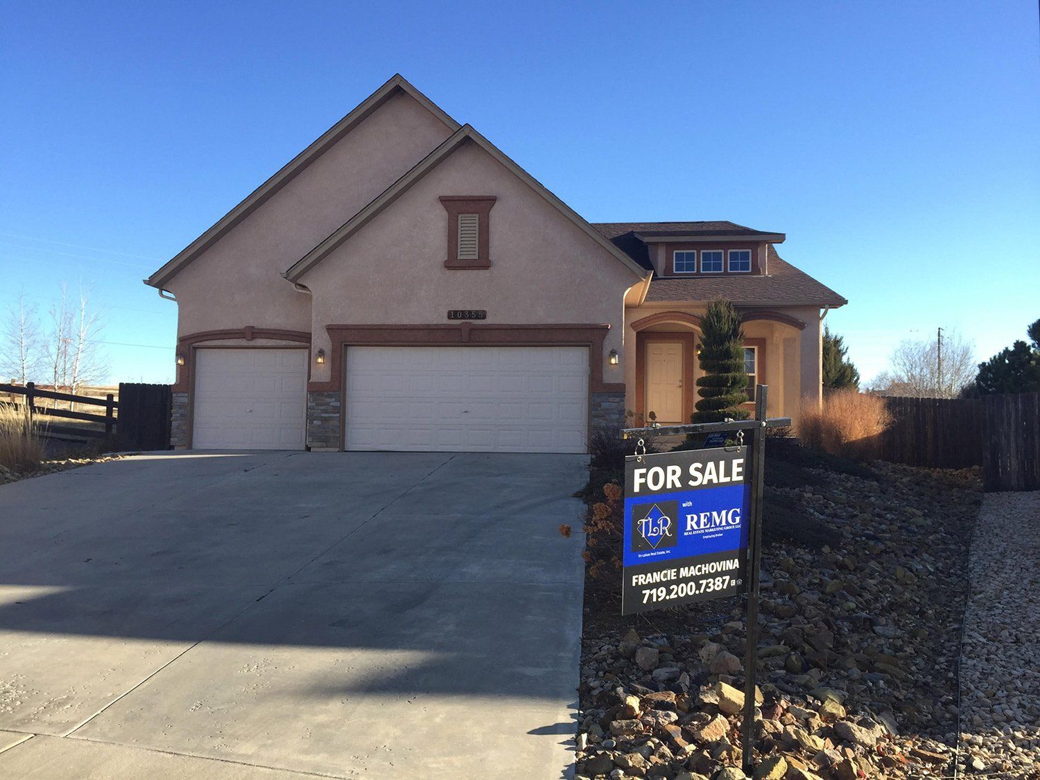 A house with a for sale sign in front of it