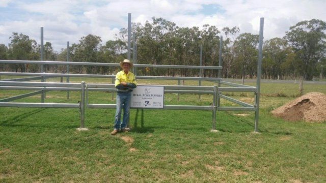 A man standing near the garden