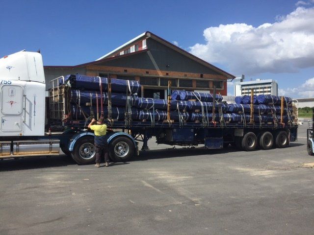 Fence post packed and straped pipes on trailer