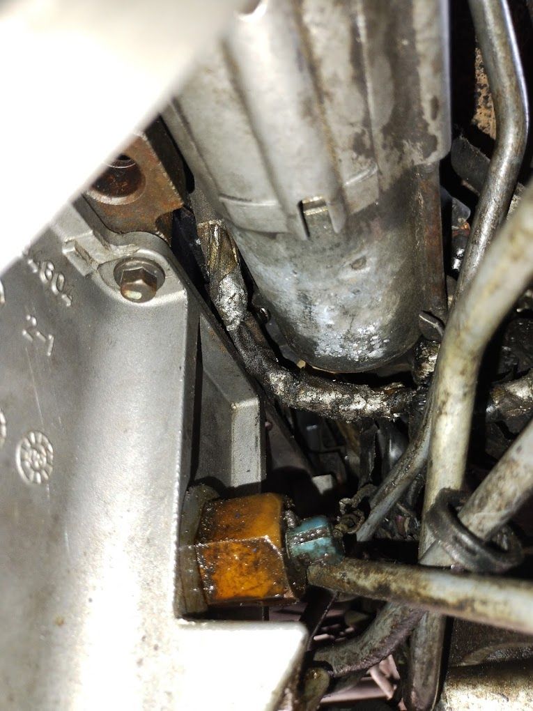 A close up of a metal pipe with a hose attached to it.