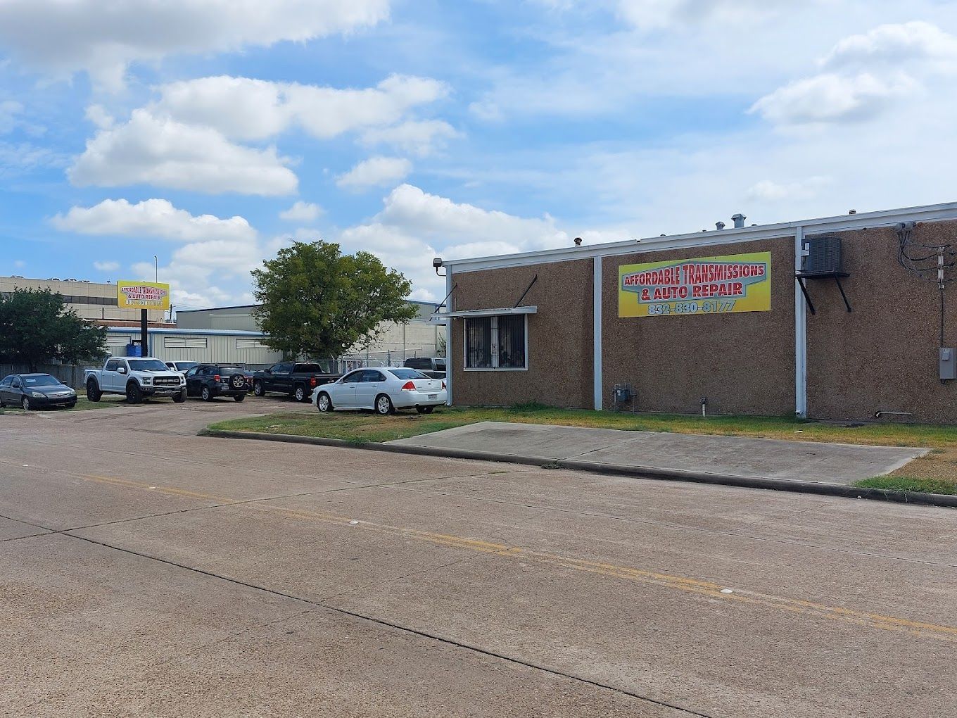 A brick building with a yellow sign on the side of it.