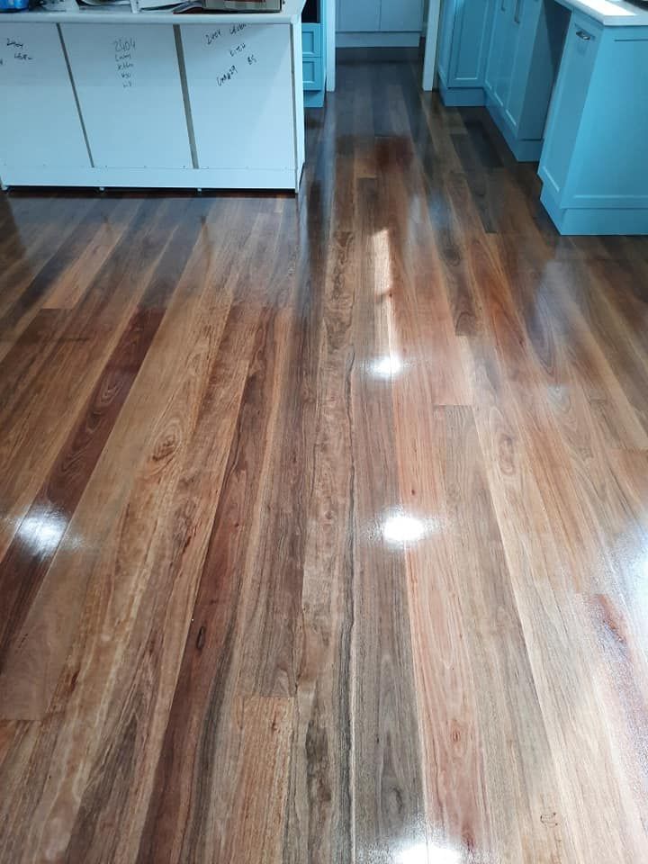 A kitchen with a wooden floor and blue cabinets