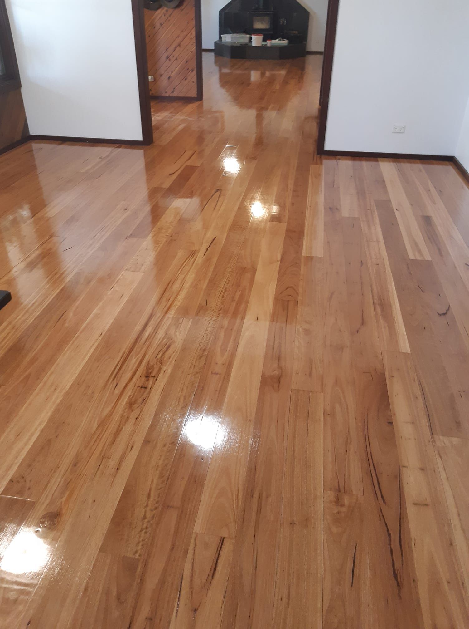 A living room with a hardwood floor and a fireplace