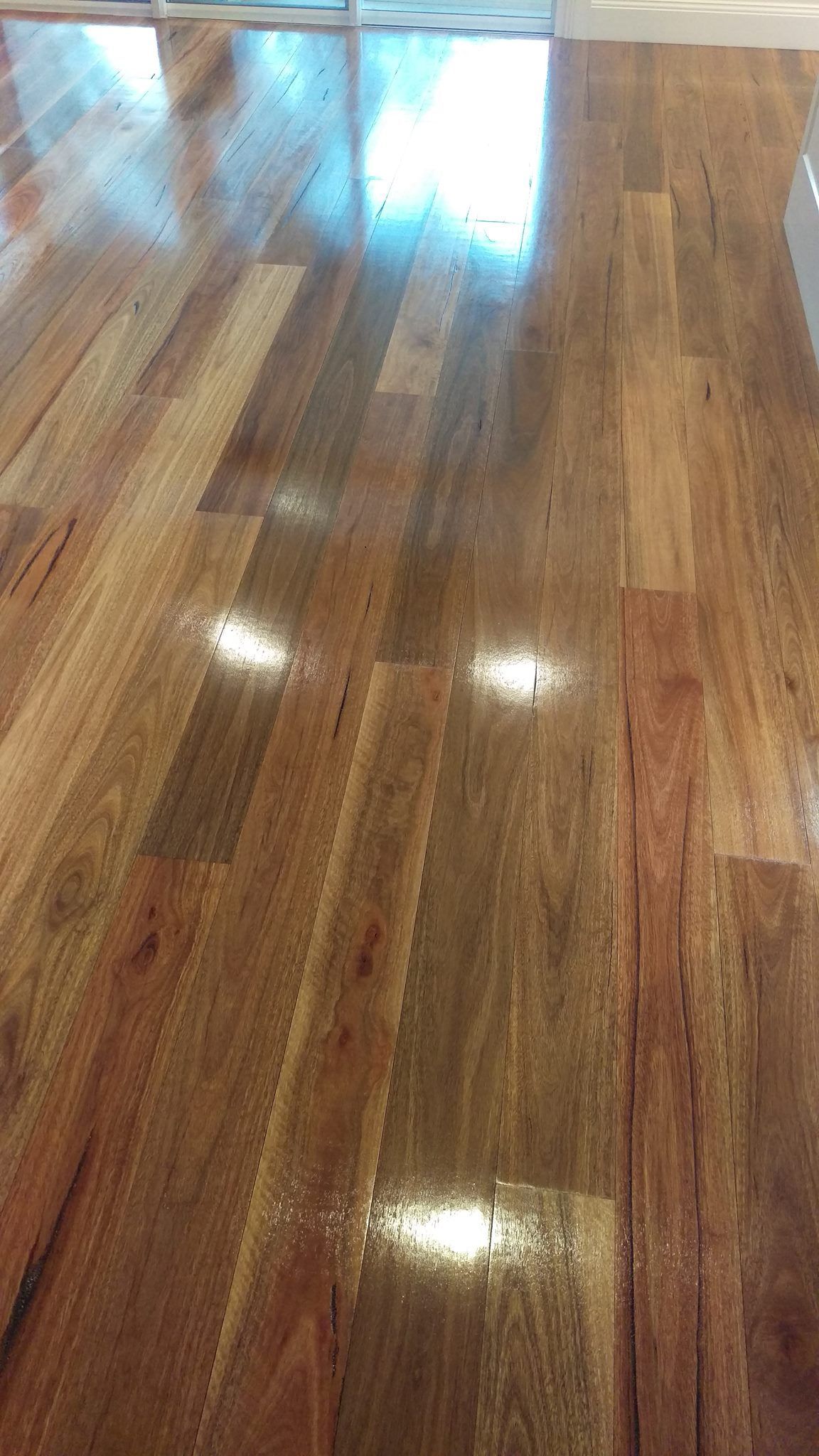 A close up of a shiny wooden floor in a room