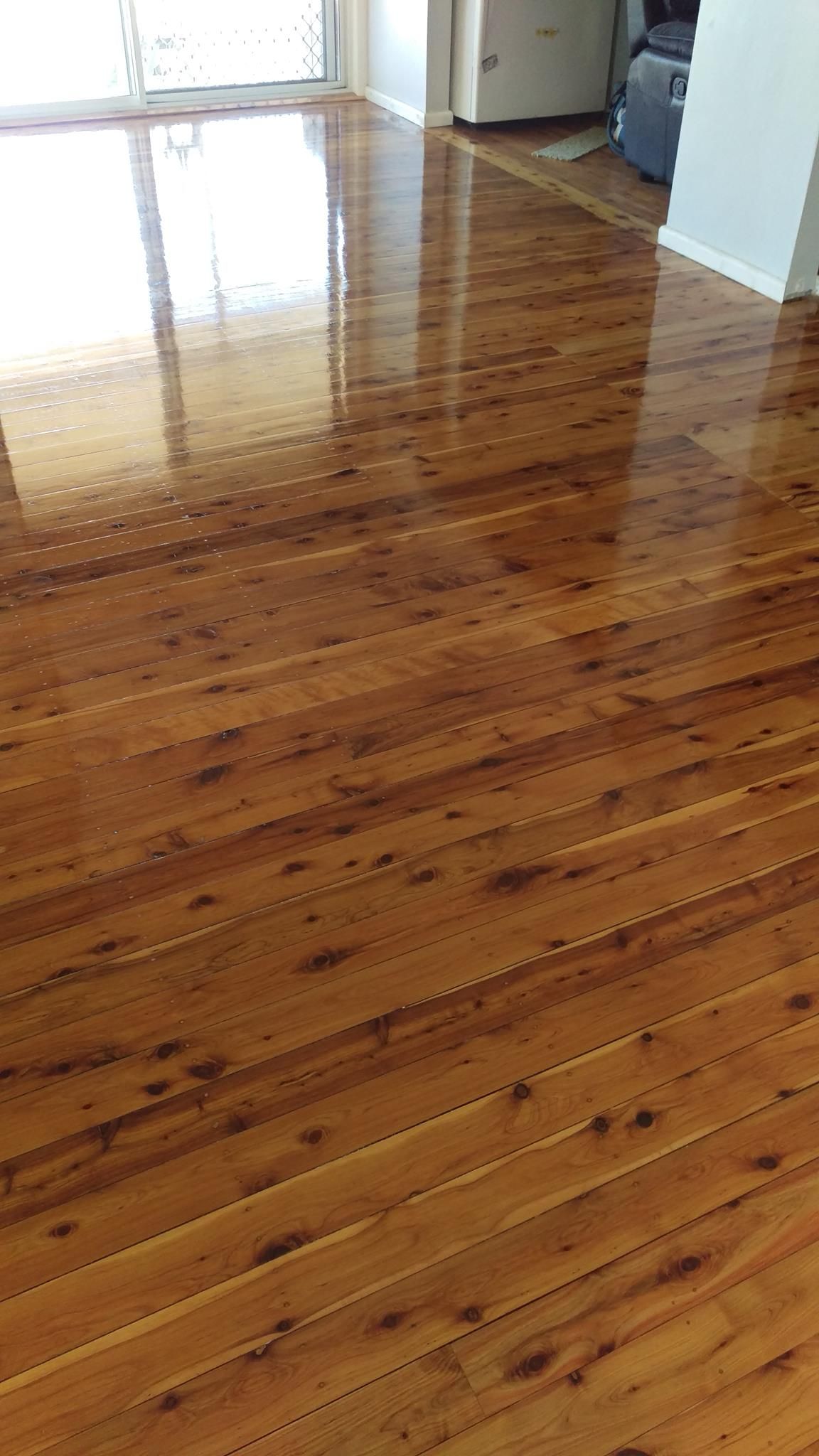 A living room with a wooden floor and a sliding glass door