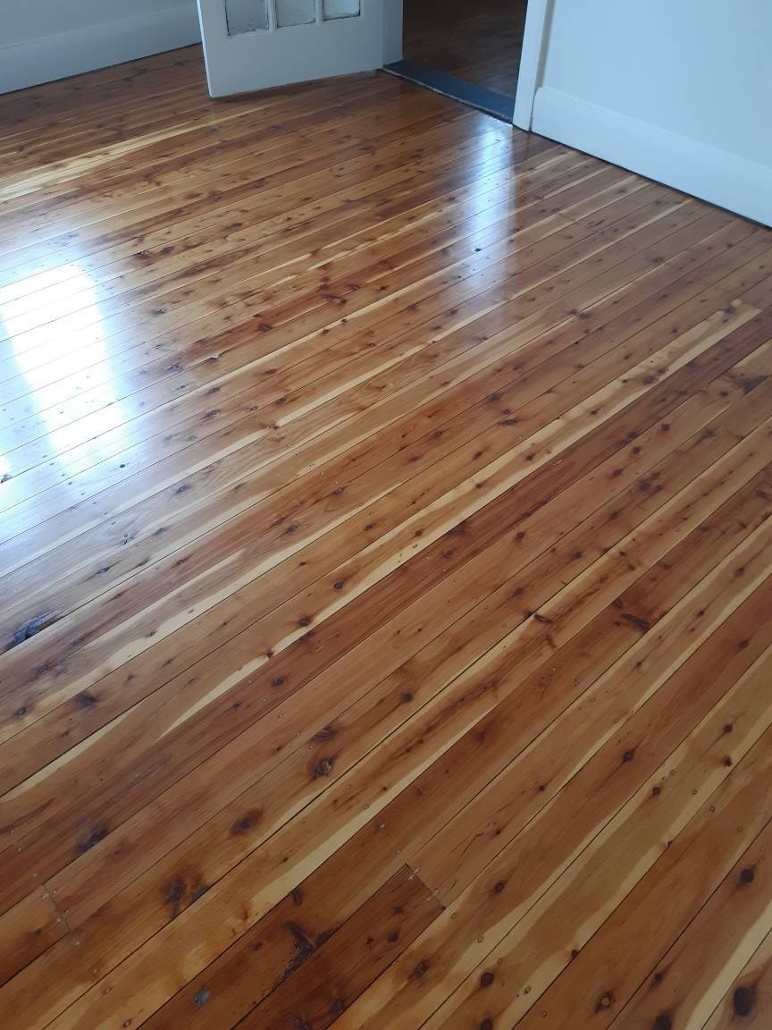 A room with a wooden floor and a door