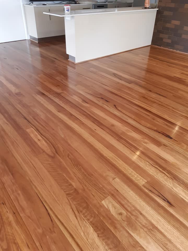 A kitchen with a wooden floor and a white counter top