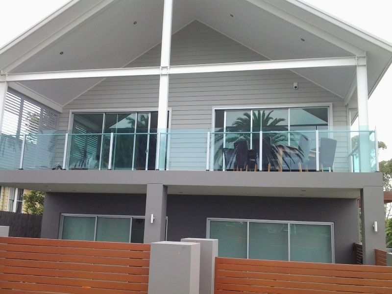A house with a balcony and a wooden fence