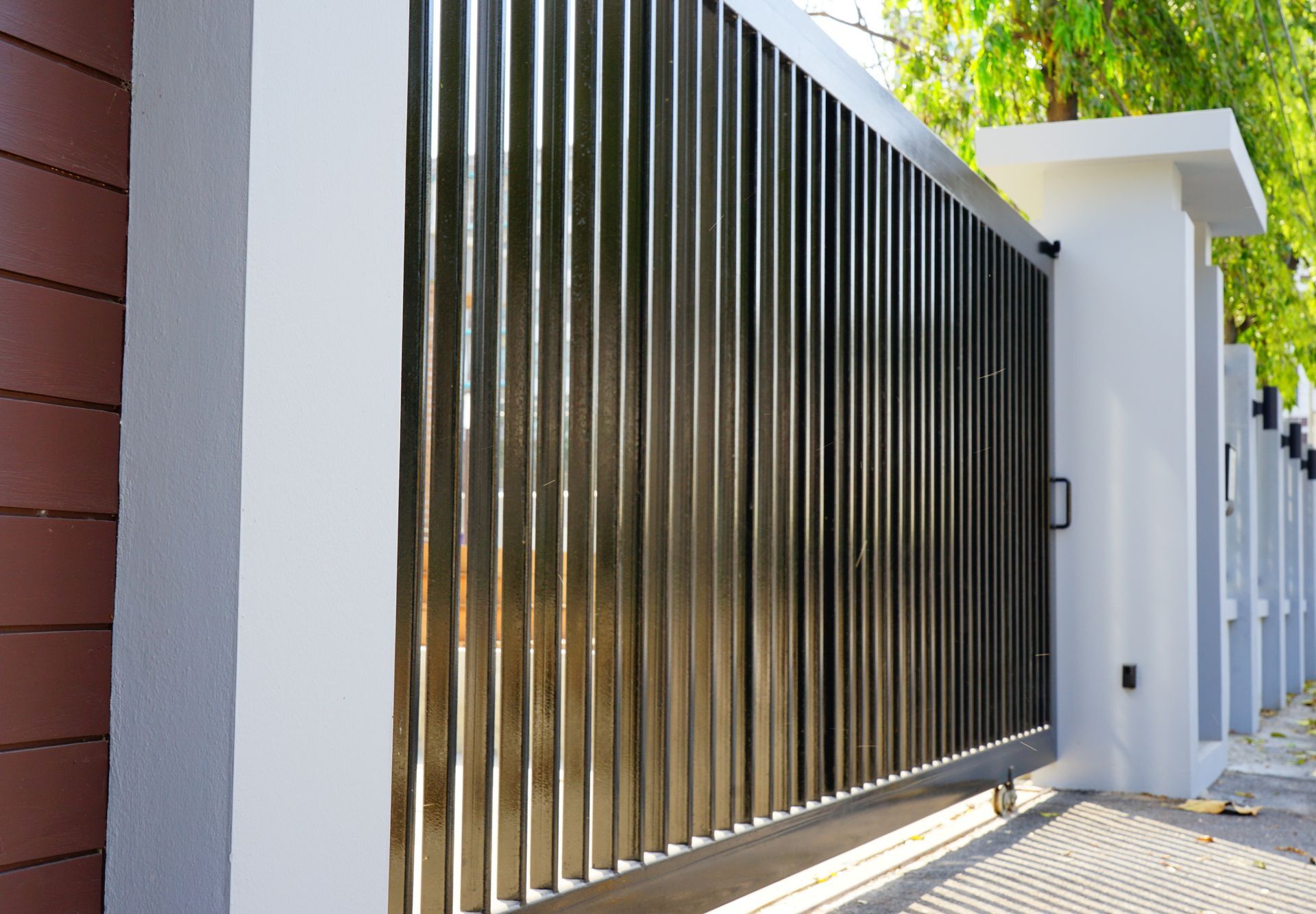 Modern black sliding gate made from aluminium, highlighting Aluminium Gate Fabrications services.