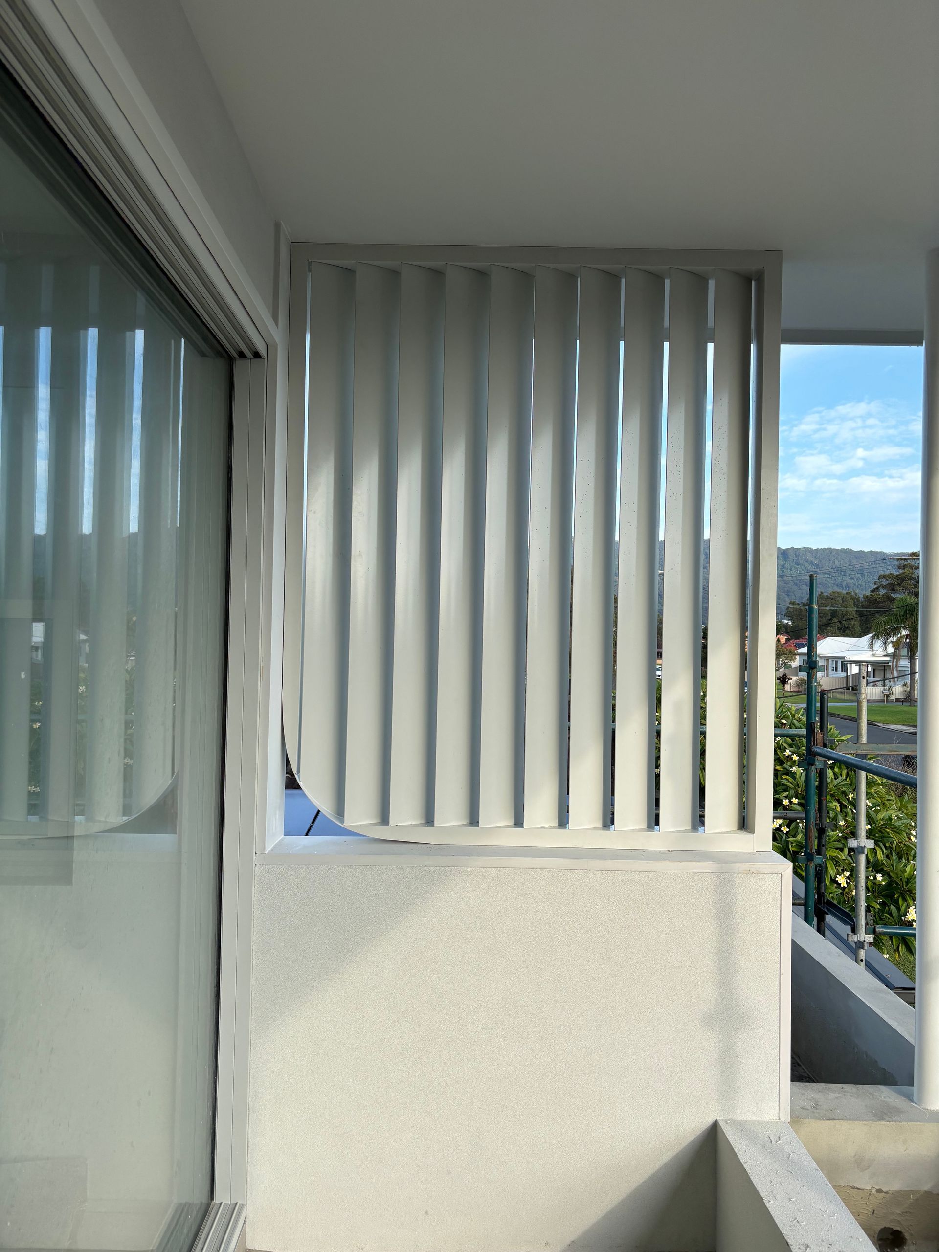 A balcony with a white fence and a window