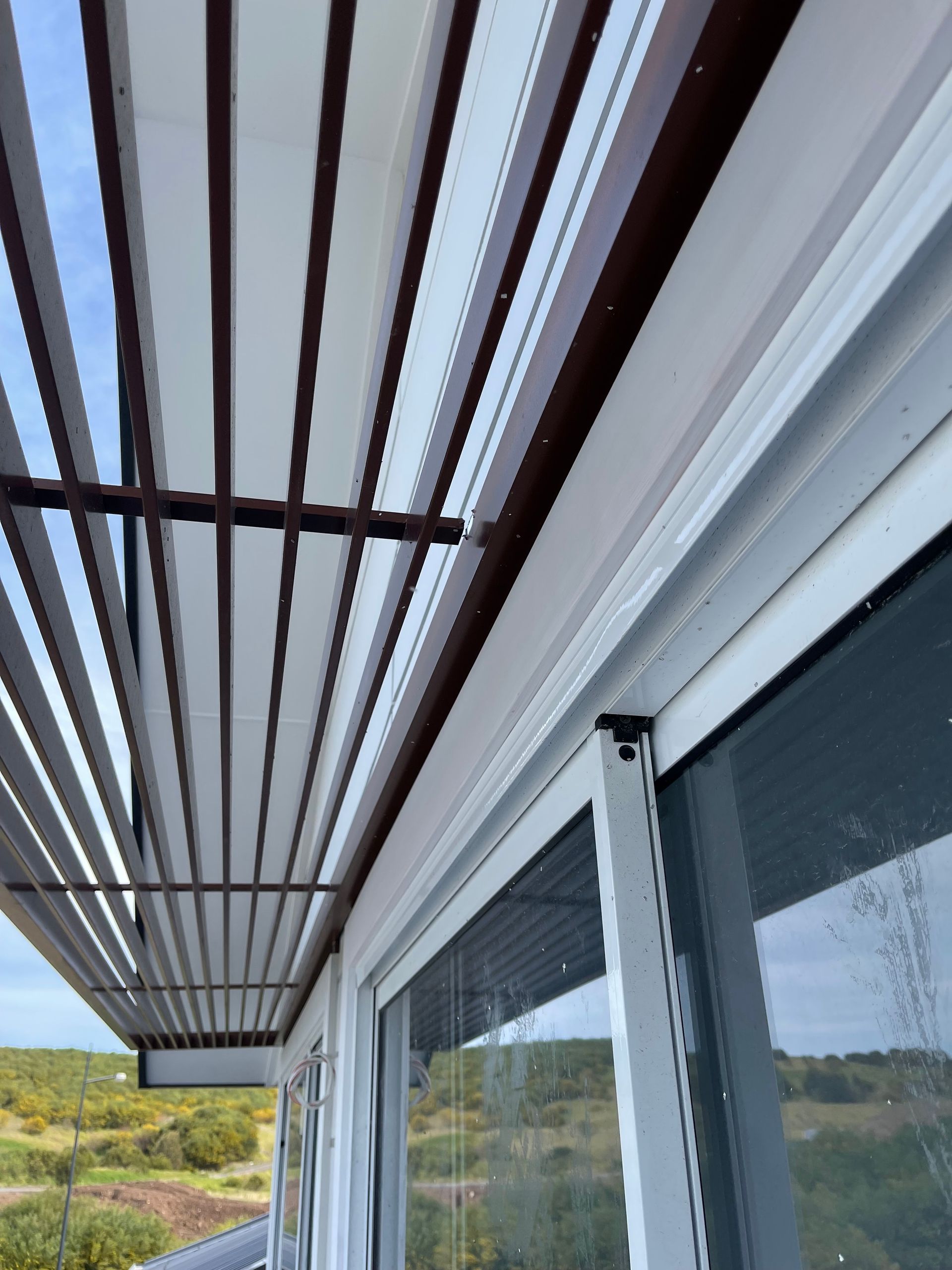 Looking up at the ceiling of a building with a sliding glass door