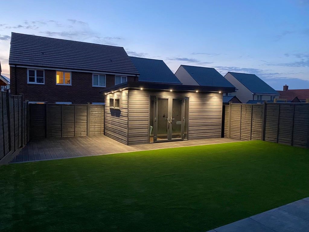 Finished product after decking and shed installation in garden,