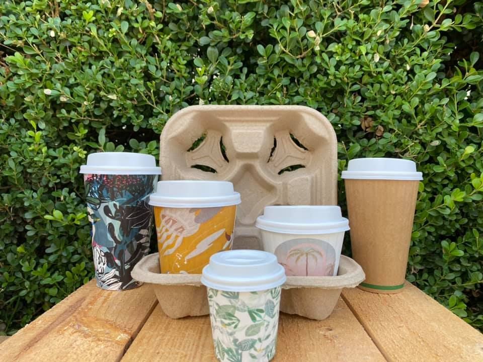 A wooden table topped with a tray of coffee cups — Labroco Gourmet Coffee Supplier In Forster, NSW