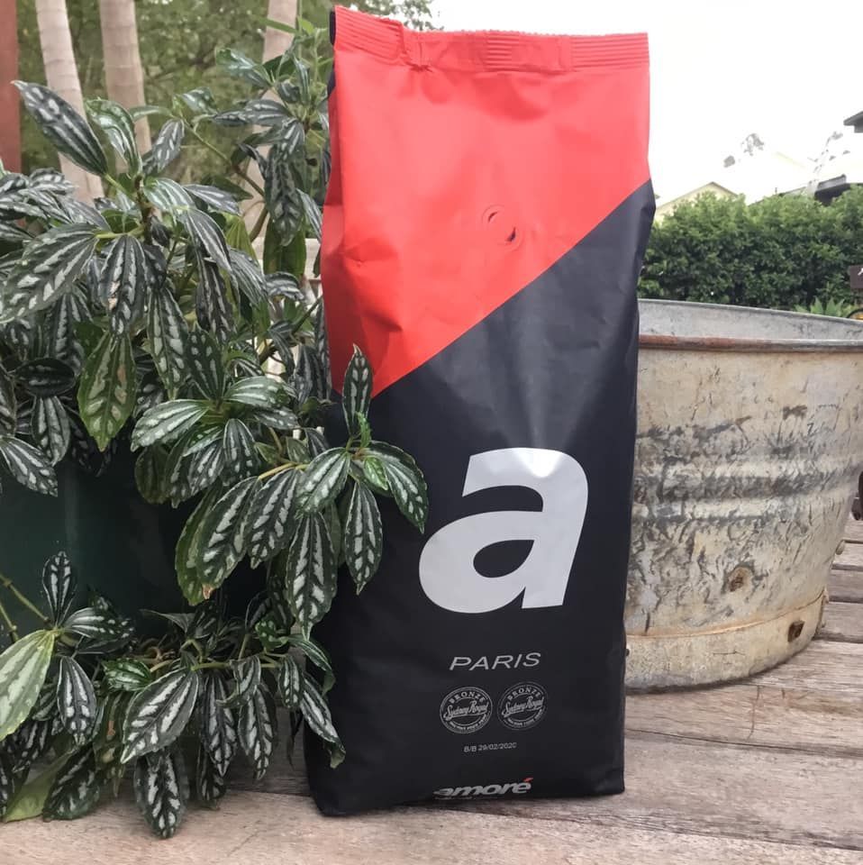 A Bag of Paris Coffee Sits Next to a Plant — Labroco Gourmet Coffee Supplier In Tea Gardens, NSW