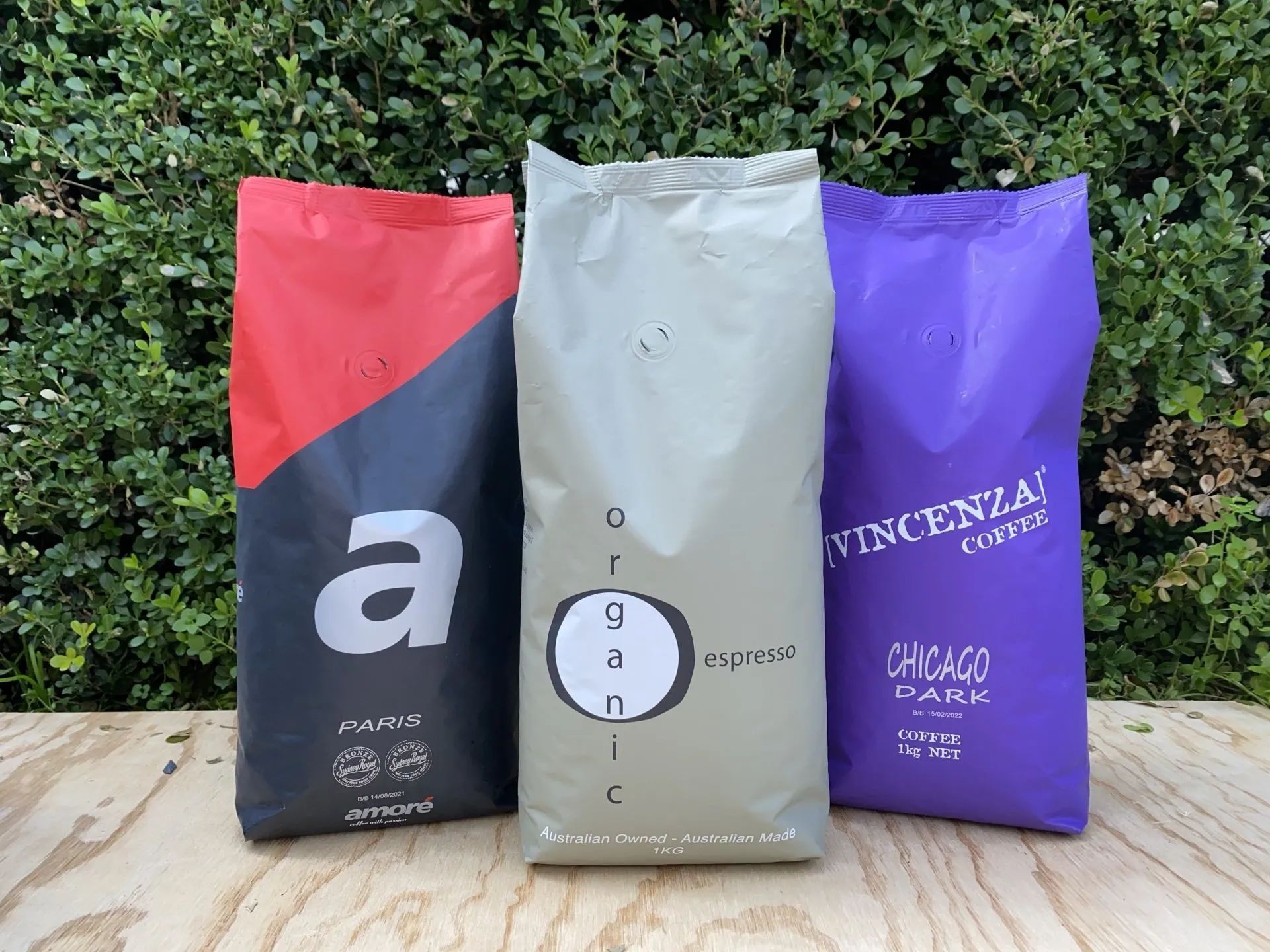 Three Bags of Coffee Are Sitting on a Wooden Table — Labroco Gourmet Coffee Supplier In Forster, NSW