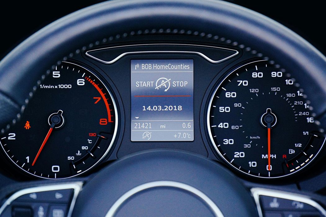 Dashboard of a car showing the speedometer, tachometer, and other digital displays.