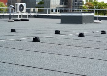 a close up of a roof with a lot of wires on it .