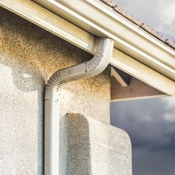 a close up of a gutter on the side of a house .