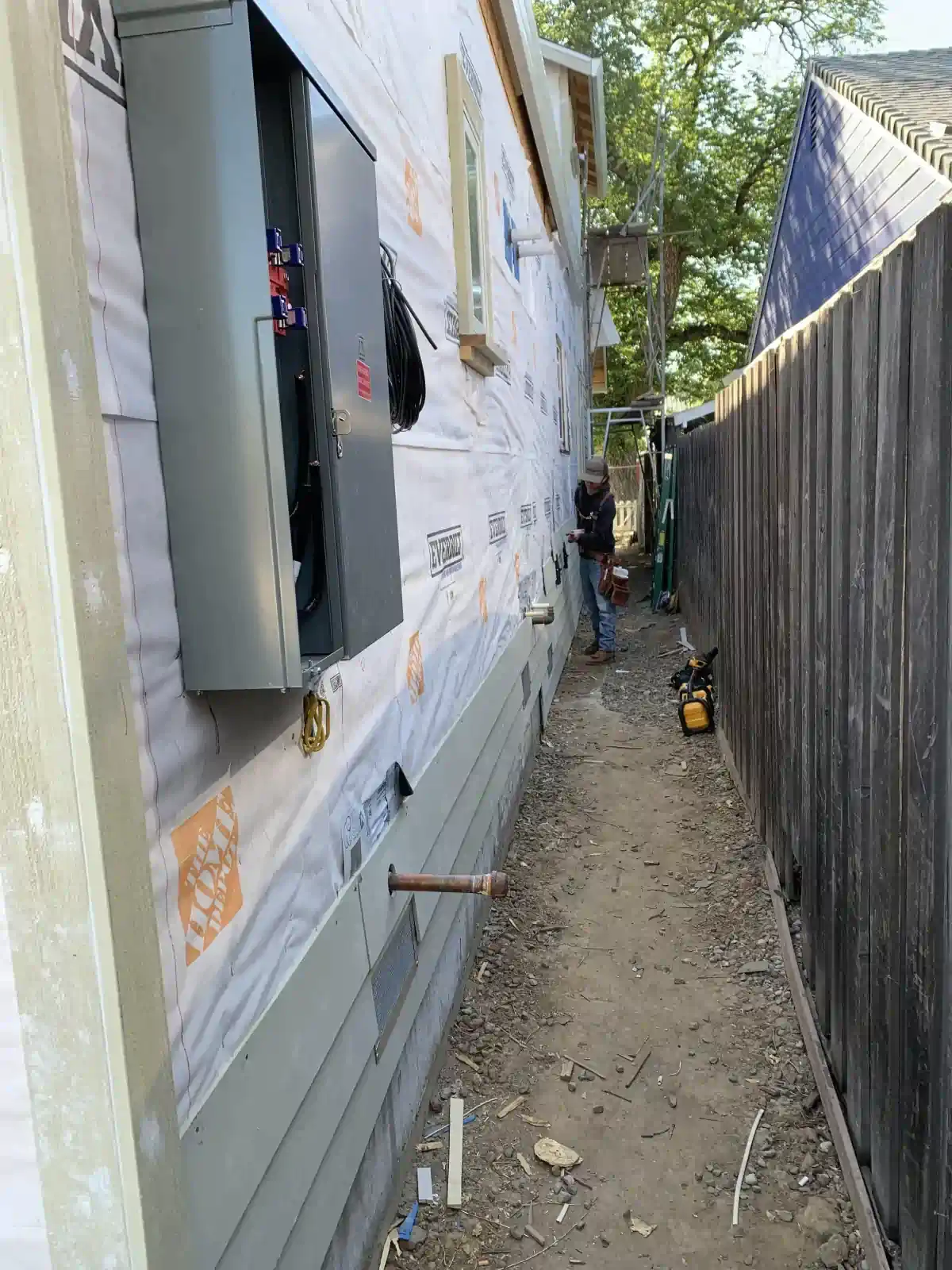 A man is working on the side of a house.