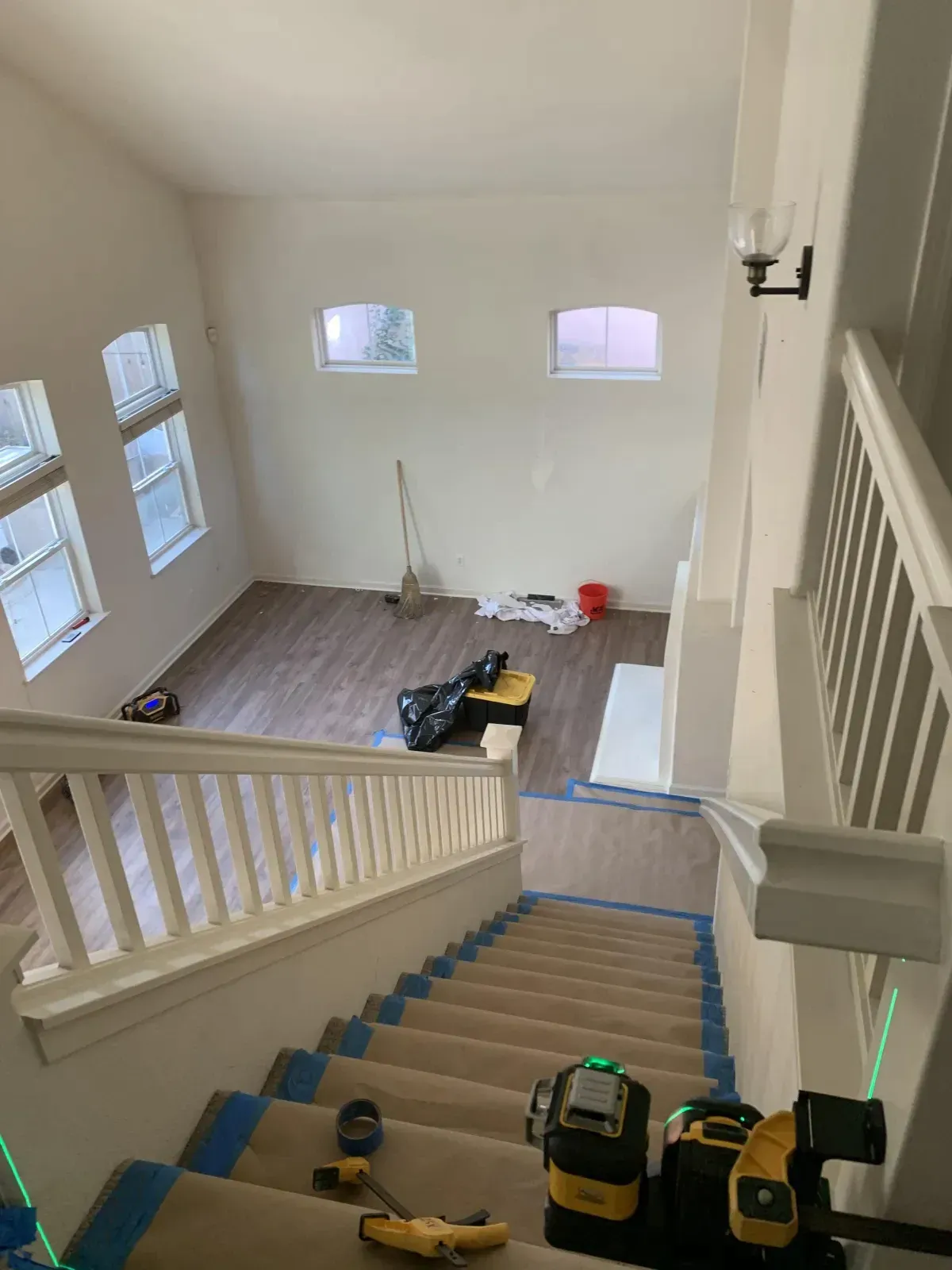 A view of a staircase from the second floor of a house being remodeled.