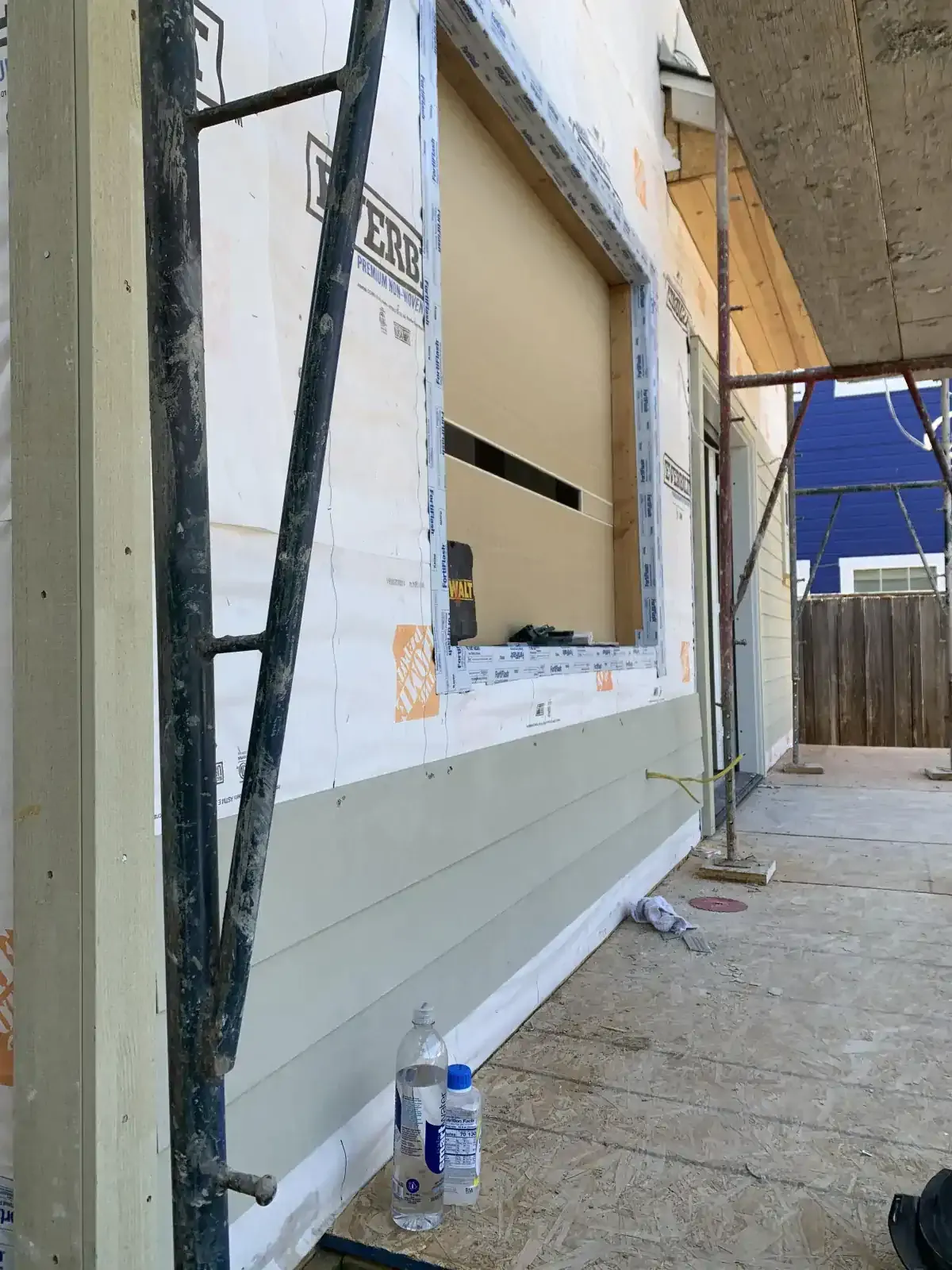 A window is being installed on the side of a building.