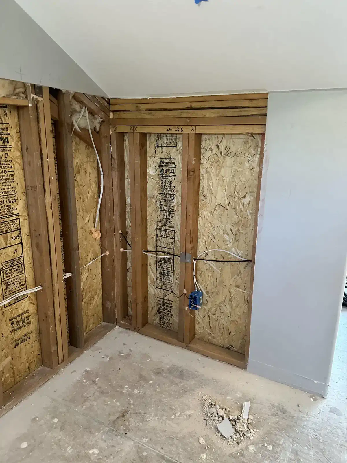 A room with wooden walls and a white ceiling.