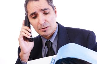 accountant working on bookkeeping and talking on the phone