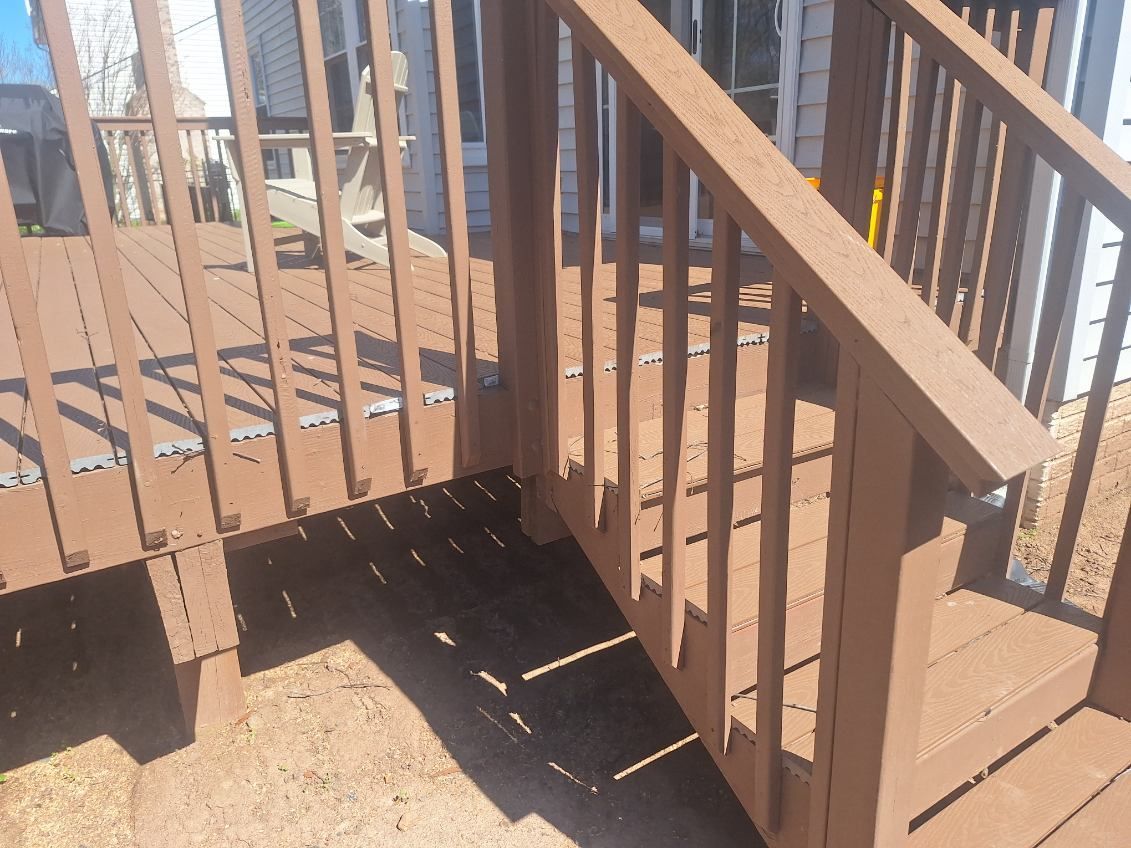 A wooden deck with stairs leading up to it
