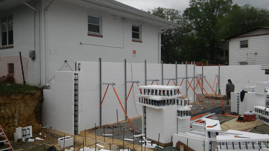 A white house is being built with styrofoam blocks