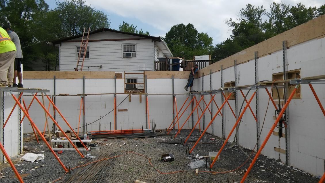 A construction site with a white house in the background