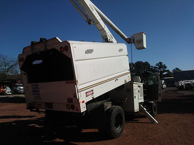 A white truck with a bucket on top of it