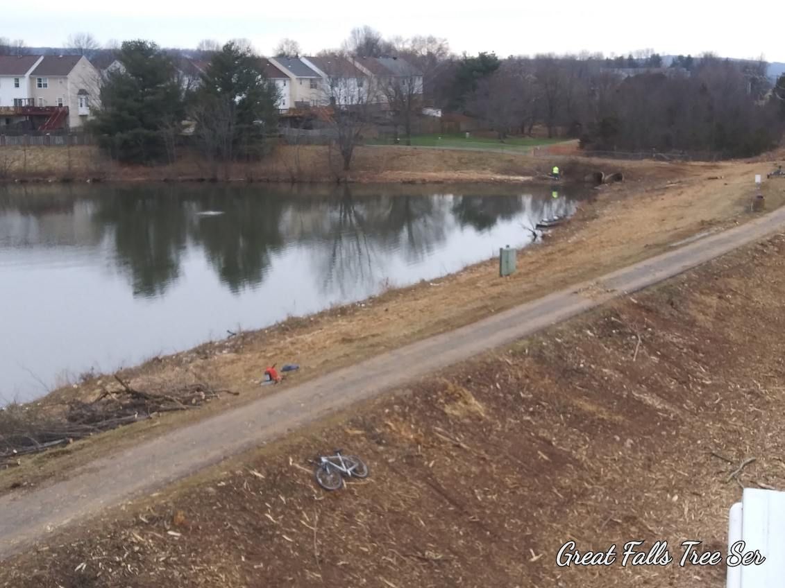An aerial view of a lake with a dirt road leading to it