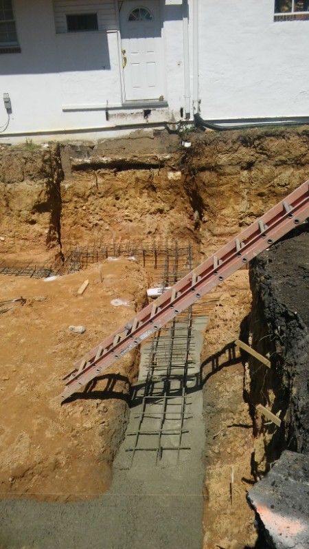 A construction site with a white house in the background