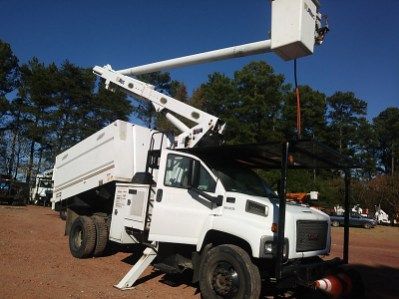 A white truck with a bucket on top of it