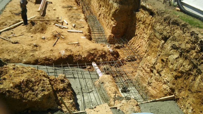 A construction site with a lot of dirt and concrete.