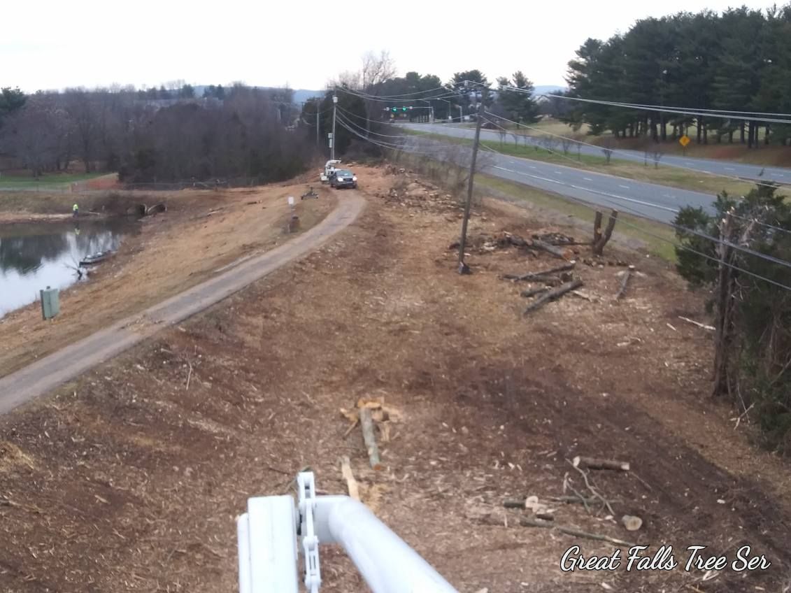 An aerial view of a dirt road with a lake in the background