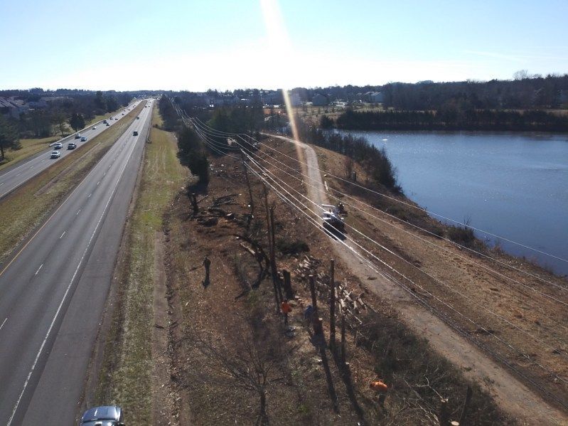 An aerial view of a highway next to a body of water.